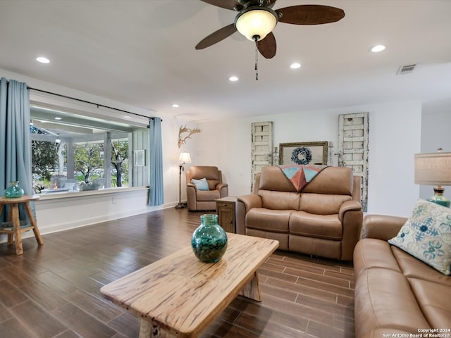 living room with ceiling fan and dark wood-type flooring