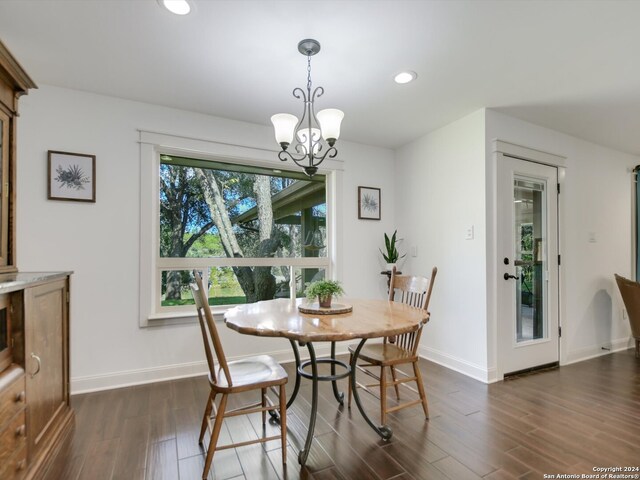 dining space with a chandelier and dark wood-type flooring