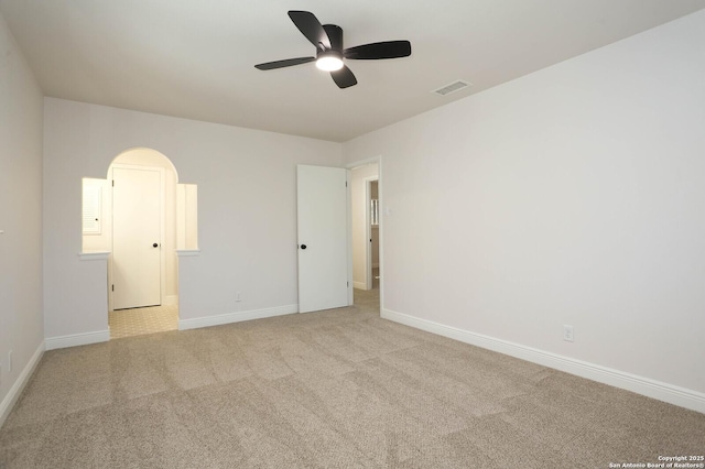 empty room with visible vents, a ceiling fan, baseboards, and carpet floors