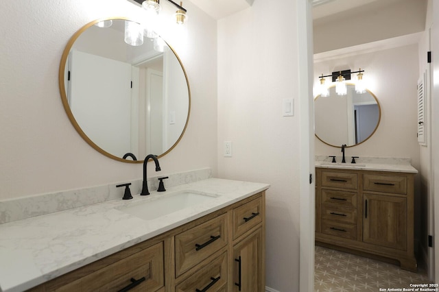 bathroom with a sink and two vanities