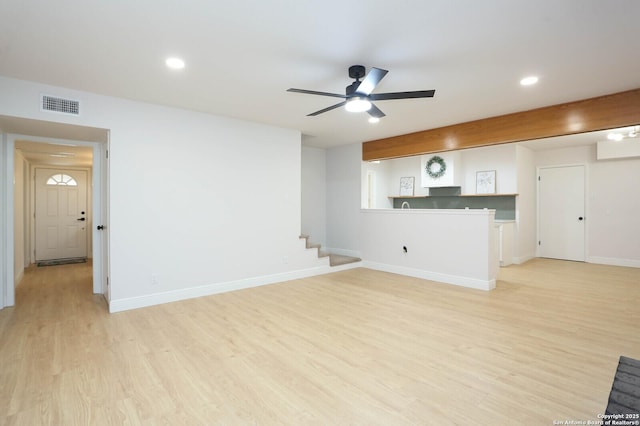 unfurnished living room with a ceiling fan, visible vents, baseboards, recessed lighting, and light wood-style floors