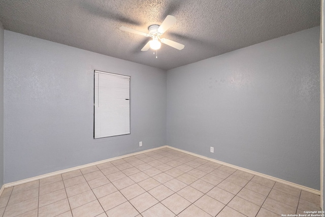 tiled spare room with ceiling fan and a textured ceiling