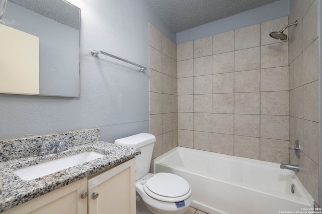 full bathroom featuring vanity, tiled shower / bath combo, a textured ceiling, and toilet