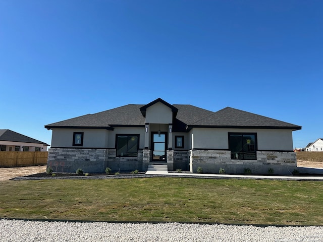 prairie-style house featuring a front lawn