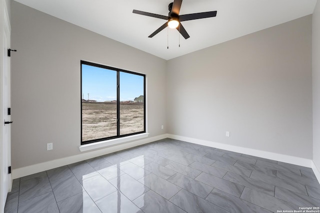 tiled empty room featuring ceiling fan