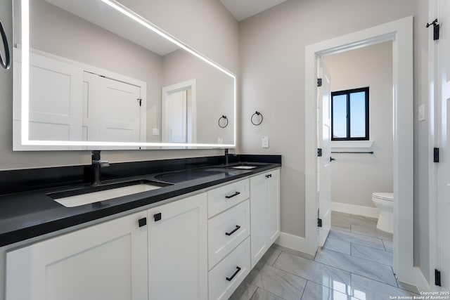 bathroom featuring vanity and toilet