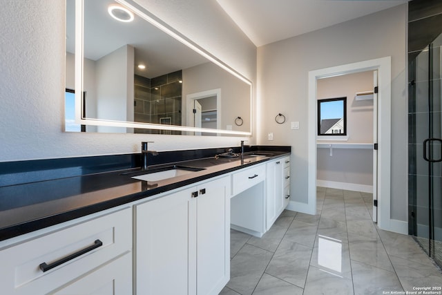 bathroom featuring vanity and an enclosed shower