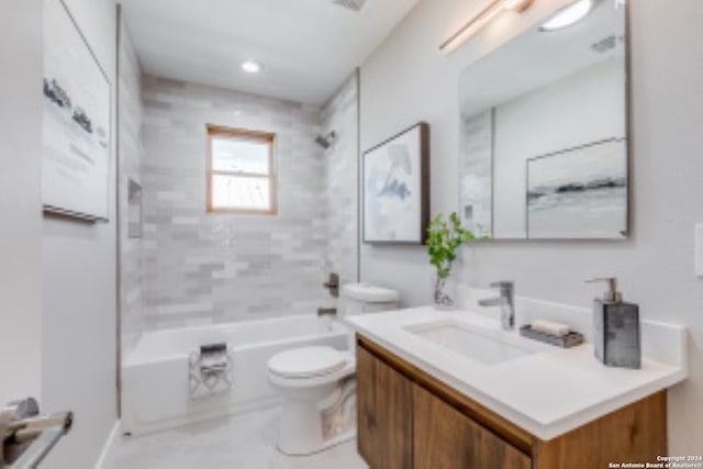 full bathroom with tiled shower / bath combo, toilet, and vanity