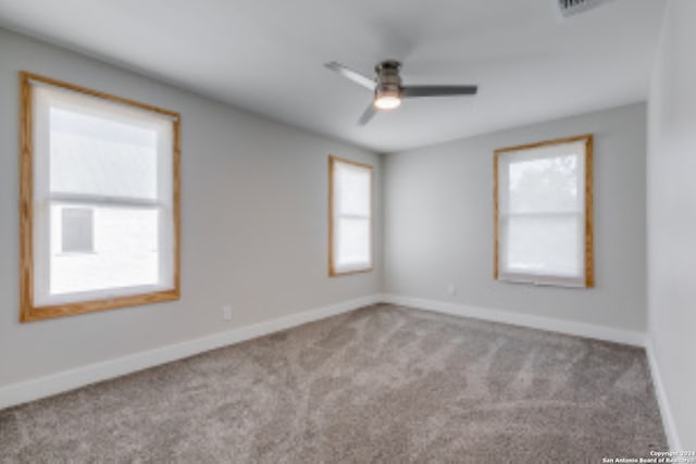 unfurnished room featuring light carpet and ceiling fan