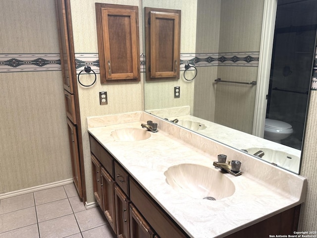 bathroom featuring wallpapered walls and a sink