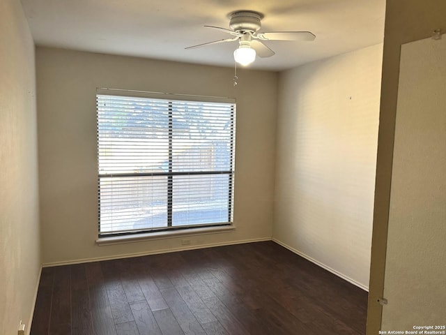 unfurnished room featuring a ceiling fan and dark wood-style flooring