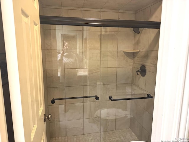 full bath with a shower stall and toilet