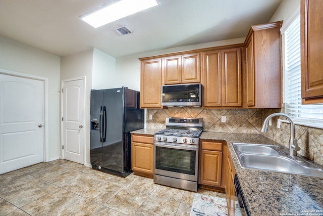 kitchen featuring appliances with stainless steel finishes, backsplash, plenty of natural light, and sink