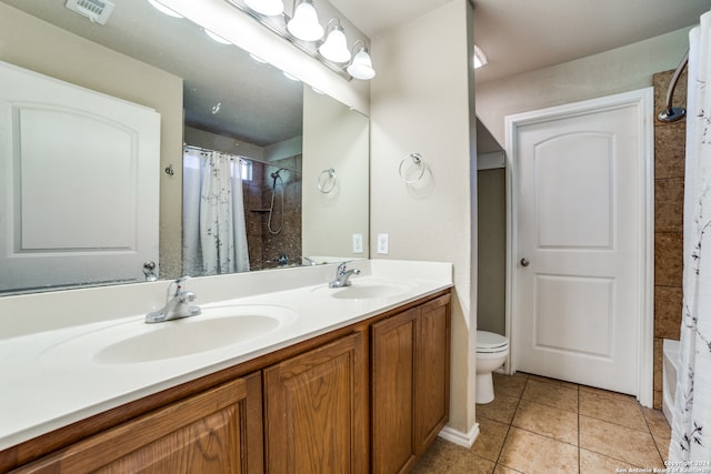 full bathroom featuring tile patterned floors, shower / bath combo with shower curtain, vanity, and toilet