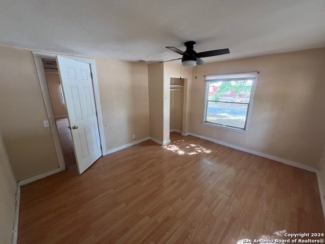 unfurnished bedroom featuring ceiling fan and hardwood / wood-style flooring