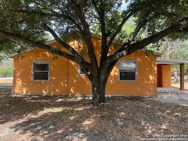 view of side of home featuring a carport