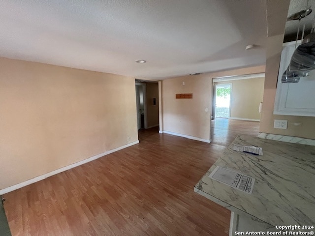 unfurnished room with hardwood / wood-style flooring