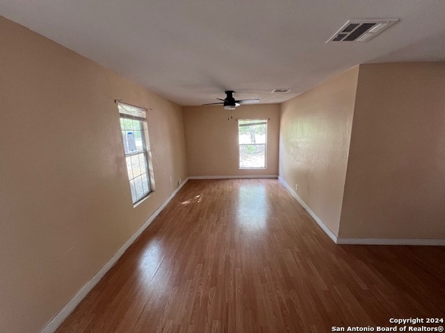 spare room featuring ceiling fan and hardwood / wood-style flooring