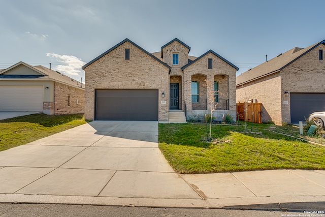 view of front of house with a front yard and a garage