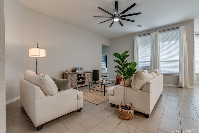 tiled living room with ceiling fan