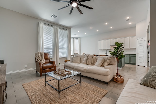 living room featuring ceiling fan and light tile patterned floors