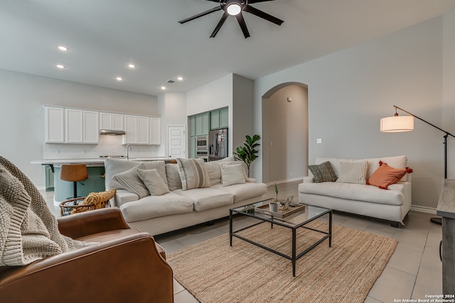 living room featuring light tile patterned floors and ceiling fan