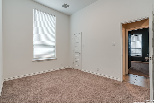 unfurnished room with light carpet