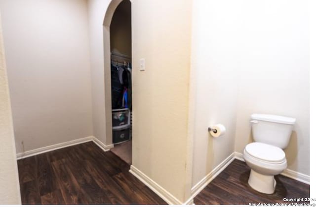 bathroom featuring hardwood / wood-style floors and toilet