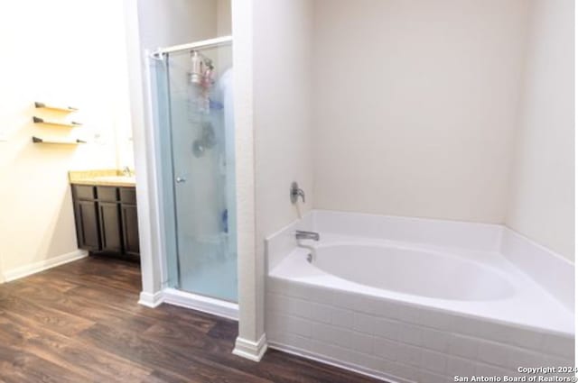 bathroom featuring hardwood / wood-style flooring, vanity, and independent shower and bath