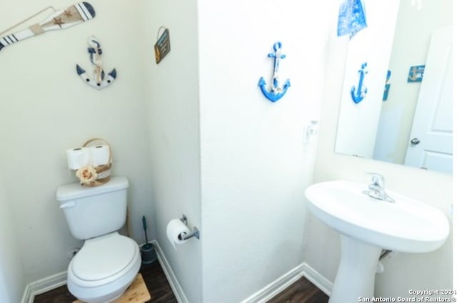 bathroom featuring hardwood / wood-style floors and toilet