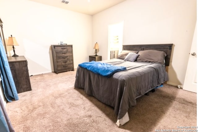 bedroom featuring light colored carpet