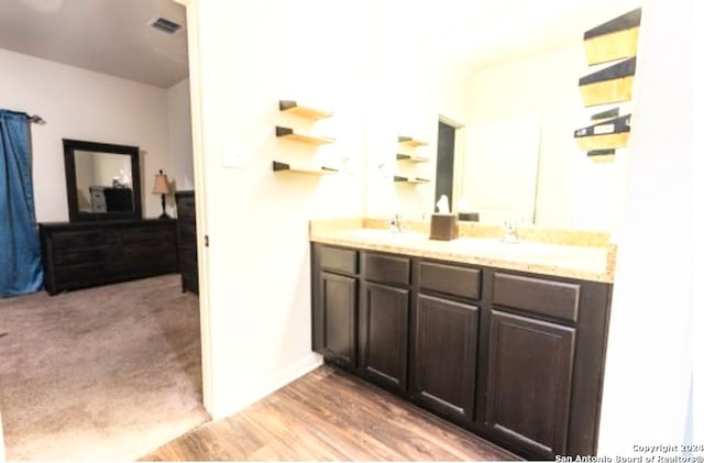 bathroom featuring hardwood / wood-style flooring and vanity