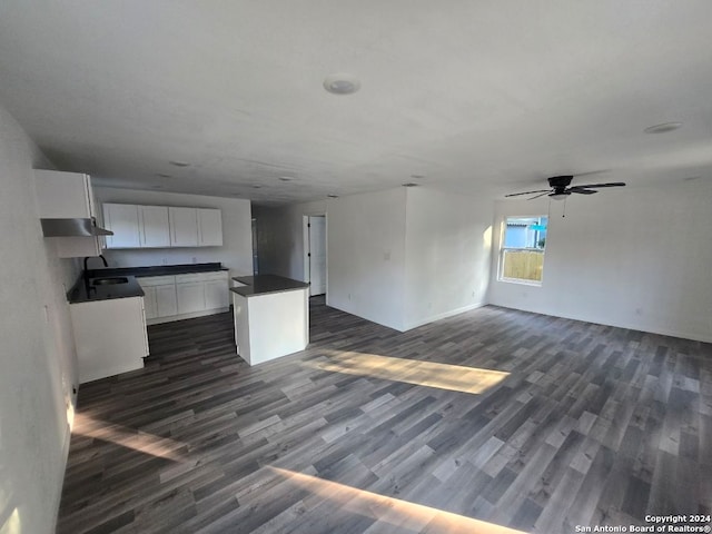 kitchen with dark hardwood / wood-style flooring, a center island, white cabinetry, and ceiling fan