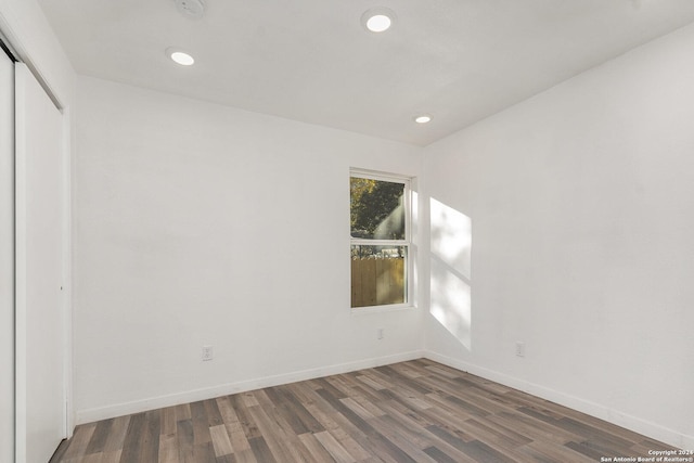 spare room with dark hardwood / wood-style floors