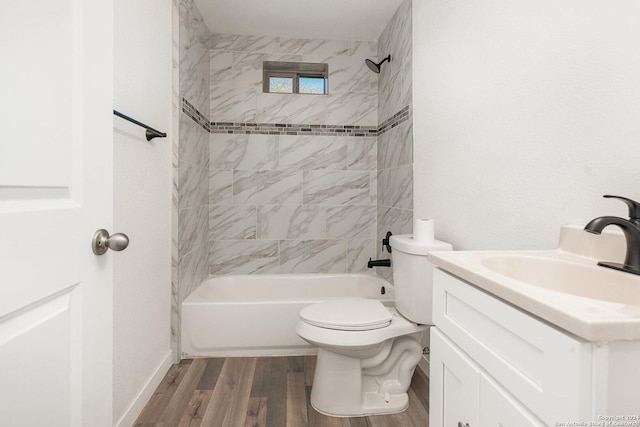 full bathroom featuring vanity, toilet, wood-type flooring, and tiled shower / bath combo