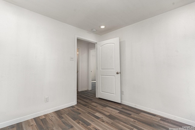 spare room with dark wood-type flooring