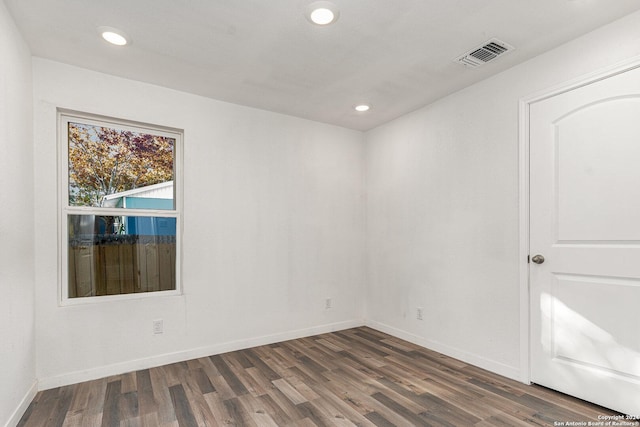 unfurnished room with dark hardwood / wood-style floors