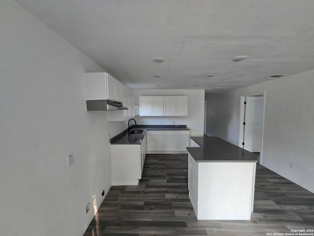 kitchen with white cabinetry, dark wood-type flooring, and sink