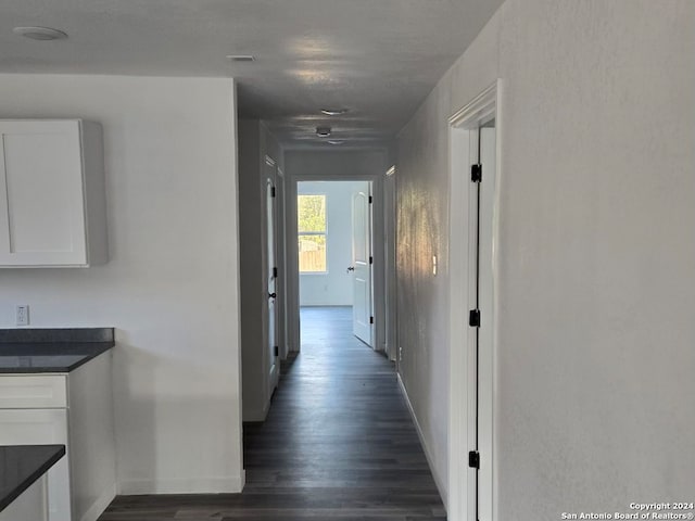 hallway with dark hardwood / wood-style flooring