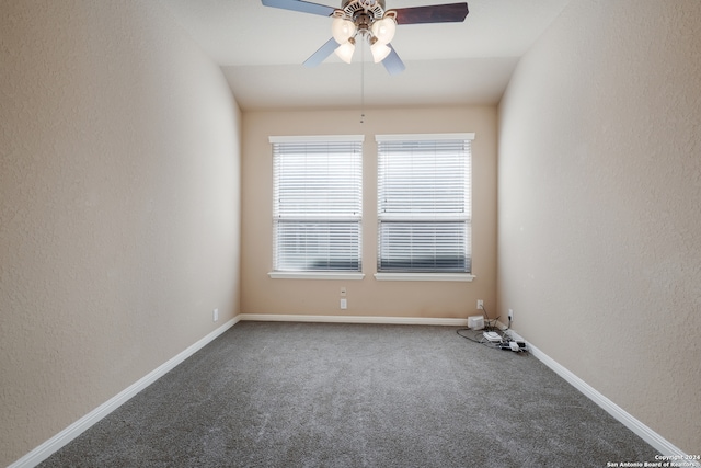 empty room with ceiling fan, carpet floors, and lofted ceiling