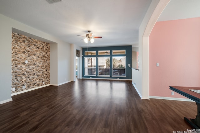 unfurnished living room with ceiling fan and dark hardwood / wood-style floors