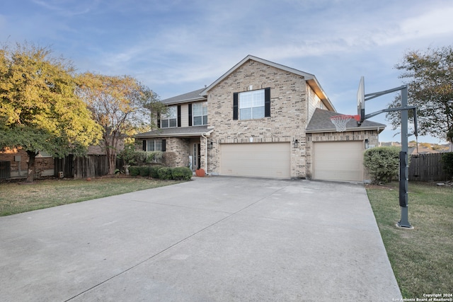 view of property with a front yard and a garage