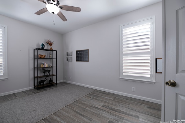 empty room featuring dark hardwood / wood-style flooring and ceiling fan