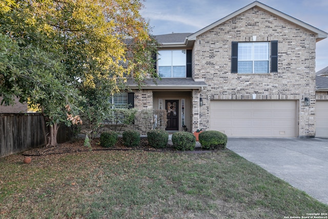 view of front of house featuring a front yard and a garage