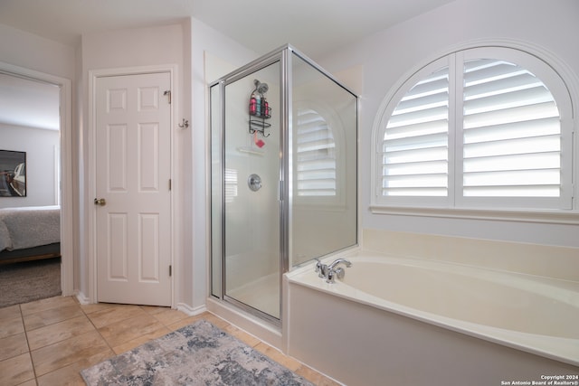 bathroom featuring shower with separate bathtub and tile patterned floors