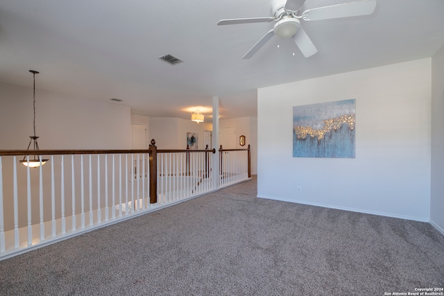 empty room featuring carpet flooring and ceiling fan