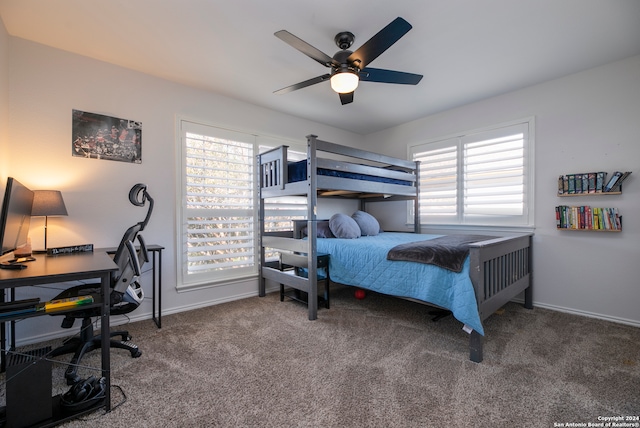 bedroom featuring carpet flooring, ceiling fan, and multiple windows