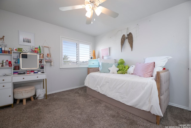 bedroom featuring ceiling fan and dark carpet