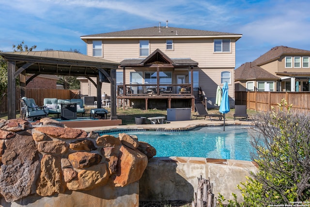 view of swimming pool featuring a gazebo, an outdoor hangout area, a patio area, and a wooden deck