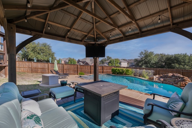 view of patio / terrace featuring a gazebo, an outdoor hangout area, and a fenced in pool